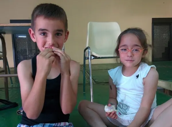 Dos ni&ntilde;os disfrutan de su merienda