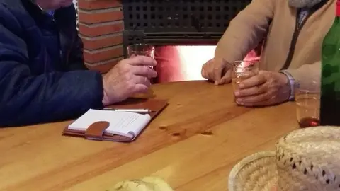 Juan Serna y Pedro Pazos toman un vino mientras charlan